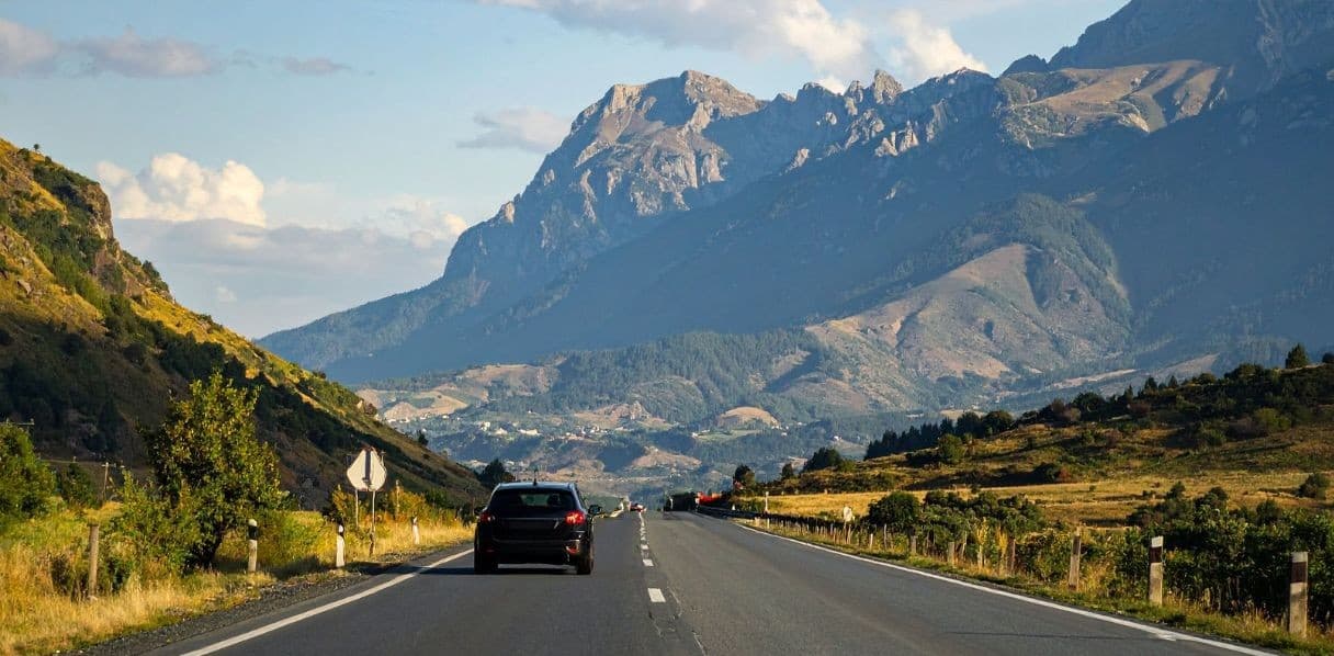 Car driving through mountain roads on a road trip